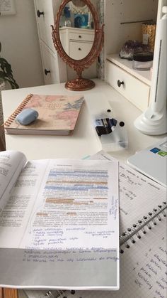 an open book sitting on top of a white desk