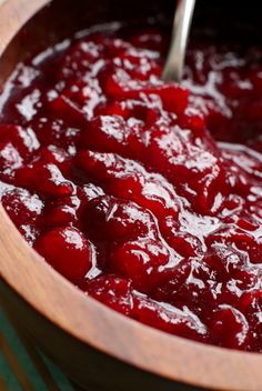 a wooden bowl filled with cranberry sauce