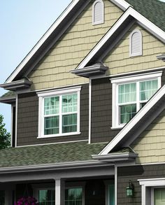 a brown house with white trim and windows