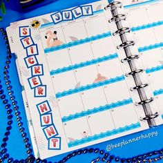 a planner with stickers on it next to beads