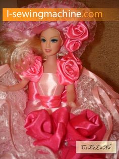 the doll is wearing a pink dress with roses on it