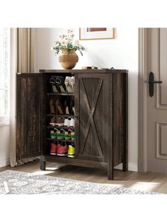 a shoe cabinet with doors open and shoes on it in front of a door that has a potted plant next to it