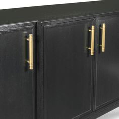 a black cabinet with gold handles and two doors on the front is shown in full view