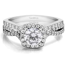 a white gold engagement ring with diamonds on the band and a center stone surrounded by smaller round