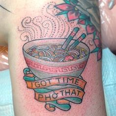 a woman with a tattoo on her arm has a bowl of noodles and chopsticks in it