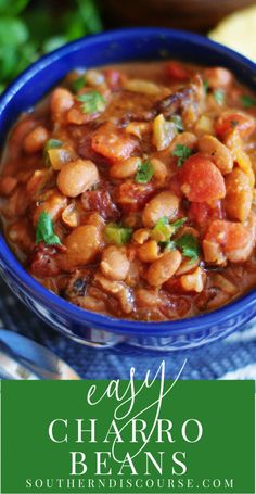 a blue bowl filled with beans and garnished with cilantro, parsleys