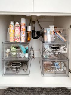 the drawers are organized with clear containers for makeup and hair care products, including hand sanitizers