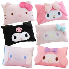 four pillows with hello kitty on them and one is pink, white, blue, black