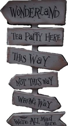 a wooden sign that says wonderland tea party here, not this way and wrong way