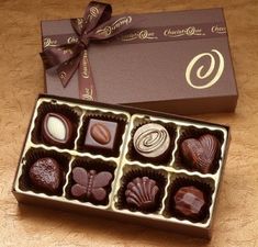 a box of chocolates sitting on top of a wooden table