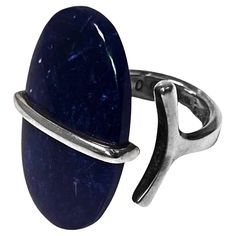 Rare Sterling Silver and Sodalite ring designed by Vivianna Torun Bulow-Hube for Georg Jensen Denmark C.1970. Stamped 925S Georg Jensen in oval dotted punch and Torun design number 190. Ring Size:8. Item Weight: 8.46 grams. Top measures: 30.0 x 17.6 mm. Torun was the first woman silversmith in the world to gain international recognition. She studied at Konstfack, the School of Arts, Crafts and Design in Stockholm, beginning in 1945 while pregnant with her first child, Pia. Eventually she married the child's father, a Danish journalism student. In 1948, Torun spent the summer in Paris meeting Picasso, Braque, Matisse, and the other great artists of the day. She married a French architect and lived in Stockholm until 1956 having a second child, a son, Claude. As early as 1952, Torun exhibite Torun Bülow-hübe, Vivianna Torun Bülow-hübe, Sodalite Ring, Paris Summer, Billie Holiday, Holiday Wear, Georg Jensen, Yellow Sapphire, Rock Crystal