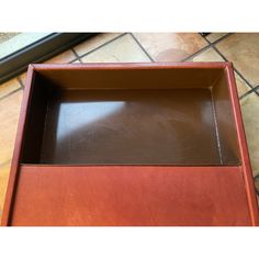 an empty wooden box sitting on the floor