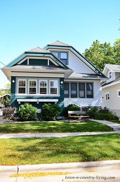 a house with green trim and white windows