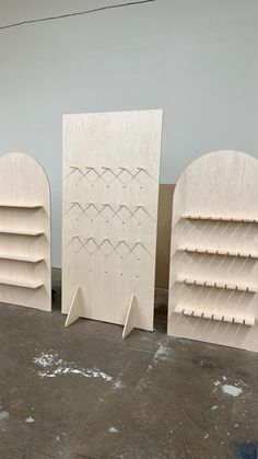 three unfinished wooden bookshelves sitting next to each other