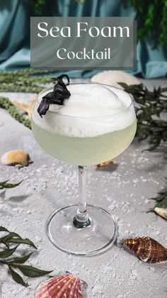 a cocktail in a glass with sea foam on the rim