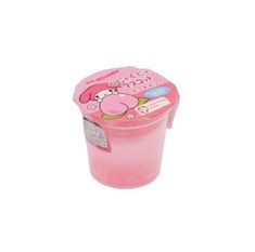 a pink plastic container filled with food on top of a white surface