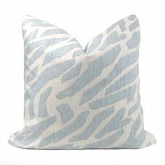 a blue and white zebra print pillow on a white background