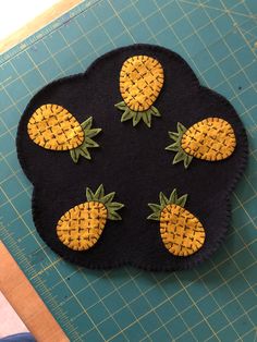 a piece of felt with pineapples on it