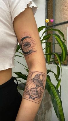 a woman's arm with an all seeing eye tattoo on the left side of her arm