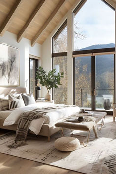 a bedroom with large windows overlooking the mountains