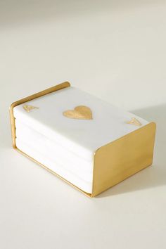 a white and gold cake with hearts on it