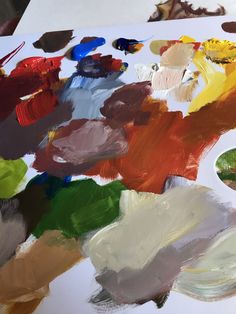 an artist's palette with many different colored paints