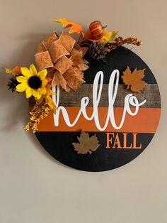 a sign that says hello fall with sunflowers and leaves