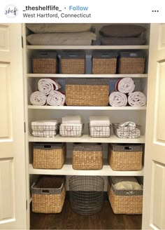 an organized closet with baskets and towels