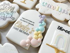 decorated cookies are arranged on a table for a child's first birthday party or celebration