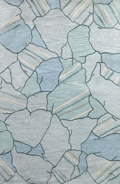 a blue and gray rug with rocks on it