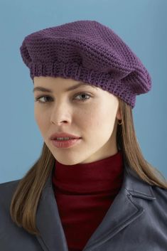 a woman wearing a purple knitted hat