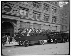 an old black and white photo of people in a new york city car on the street