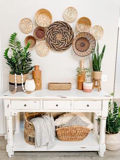 a white table topped with baskets and plants