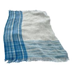 a blue and white plaid blanket on a white background