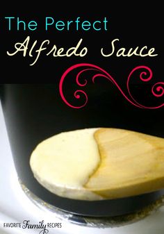 the perfect alfredo sauce is in a black cup with a wooden spoon on it and text overlay that reads, the perfect alfredo sauce