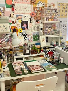 the desk has many items on it and is covered in stickers, pictures, and magnets