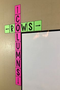 a cross made out of pink and green blocks with words across the top that read it crowns