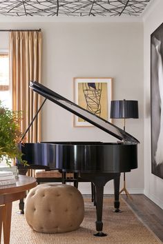 a living room with a black piano in it