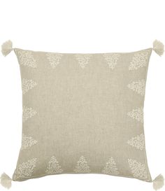 an embroidered pillow with tassels on the front and back, in light grey