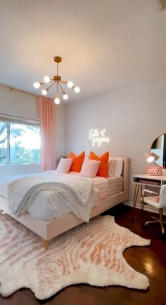 a bedroom with a white bed and orange pillows on it's covers, along with a rug that looks like a cow hide