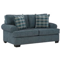 a blue couch with plaid pillows on it's arms and back cushions, against a white background