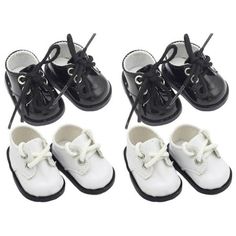 four pairs of white and black baby shoes with laces on the toes, all in different sizes