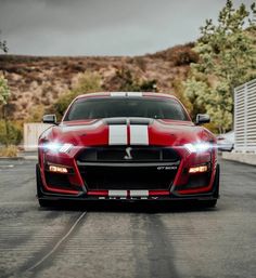 a red sports car with white stripes on it