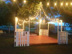 a gazebo with lights strung over it