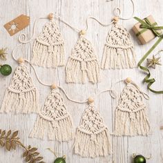 macrame tassels and ornaments on a white wooden table with green baubles