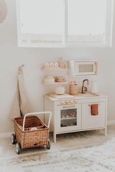 a kitchen with a white stove top oven sitting next to a basket filled with food