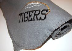 a close up of a tie with the word tigers on it