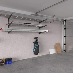 an empty garage with two surfboards on the wall and other equipment hanging from the ceiling