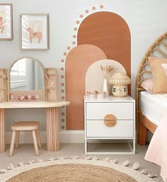 a child's bedroom decorated in pastel colors with pink and gold accessories on the bed