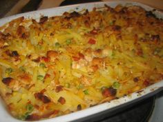 a casserole dish with chicken and vegetables in it on a stovetop top